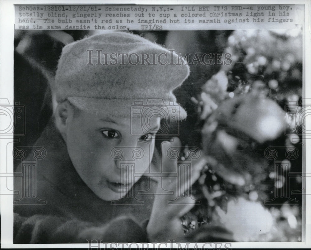 1961 Press Photo A blind boy as he reacher out a christmas ball