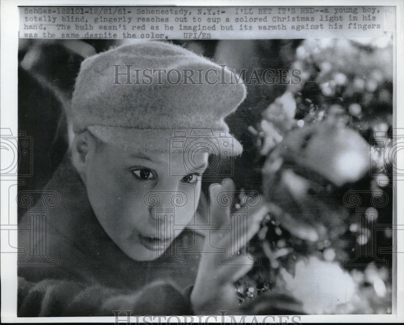 Load image into Gallery viewer, 1961 Press Photo A blind boy as he reacher out a christmas ball
