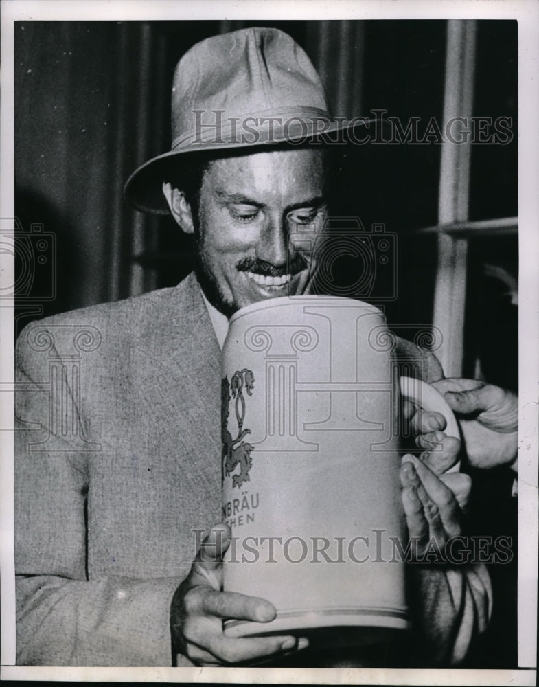 Load image into Gallery viewer, 1953 Press Photo Dr. Karl Herrigkoffer holding a huge drink - nec68442
