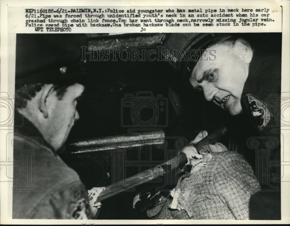 1958 Press Photo police aid youth with pipe stuck in neck (car wreck injury)- Historic Images