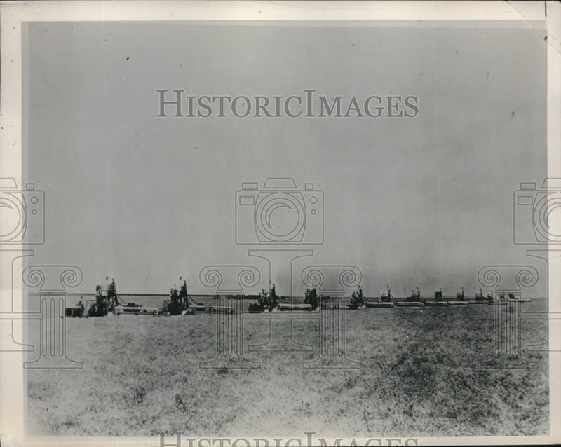 Load image into Gallery viewer, 1940 Press Photo A wheat field as harvesters pass through it
