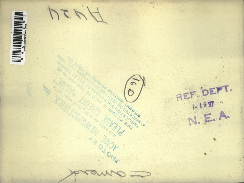 1937 Press Photo Man lays in the grass to take a photograph - nec71382