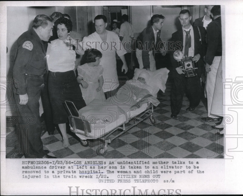 Load image into Gallery viewer, 1956 Press Photo LA, Calif Mom &amp; son with ambulance from train wreck - nec71613
