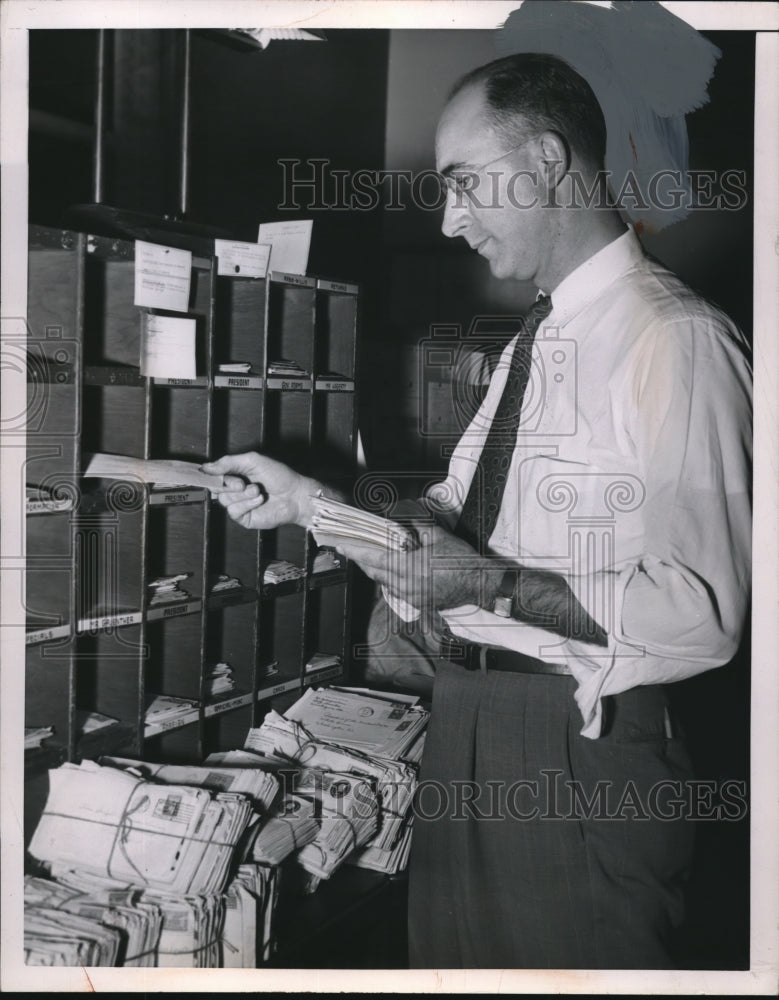 1953 Press Photo A man sortinhg mail into postal slots - nec72119