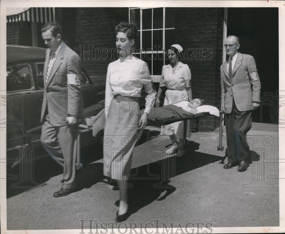 1953 Press Photo Paramedics carry victim on a cot stretcher