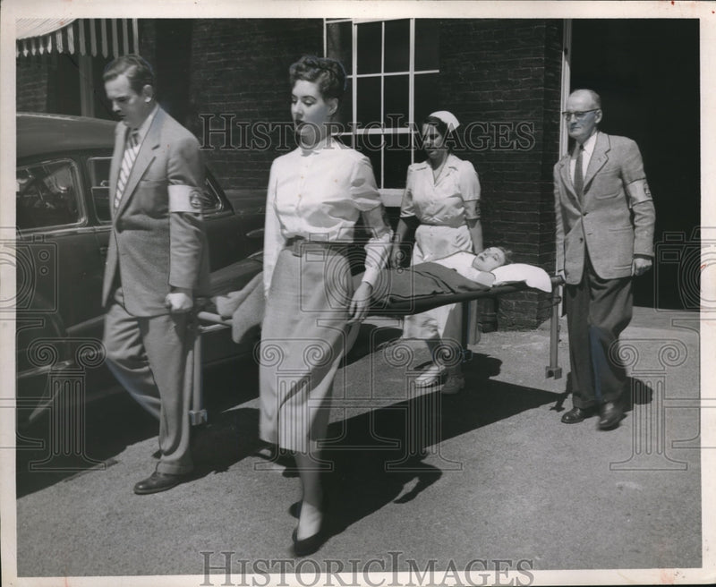 Load image into Gallery viewer, 1953 Press Photo Paramedics carry victim on a cot stretcher
