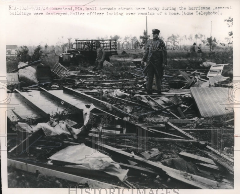 Load image into Gallery viewer, 1948 Press Photo Homestead, Fla cop in devastation of tornado strike - nec72421

