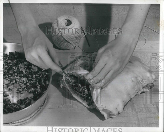 1958 Press Photo A woman prepares a lamb shoulder for cooking