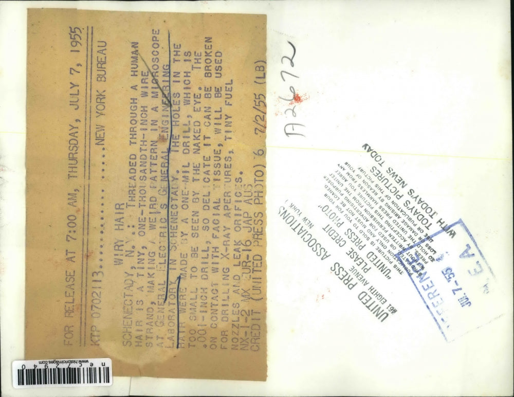 1955 Press Photo Wire Strand Threaded Through Human Hair at General Electric Lab