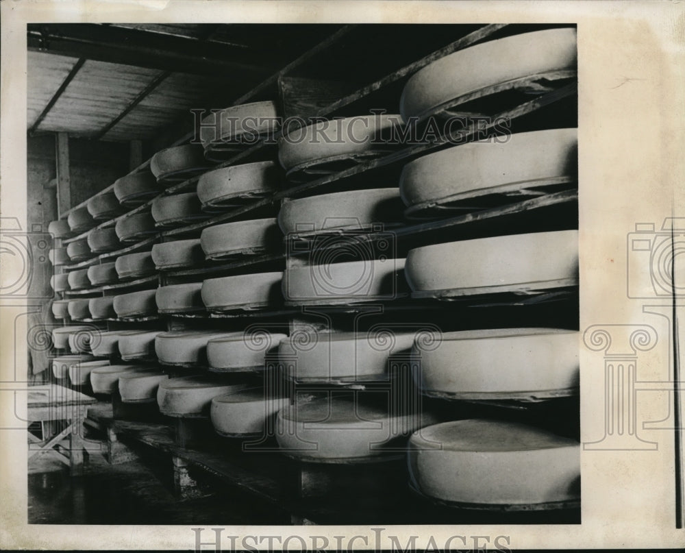 1941 Press Photo Wheels of cheese on shelves in Switzerland