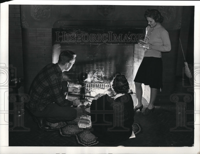 Load image into Gallery viewer, 1942 Press Photo A group of people tost weinies at a fireplace in the country
