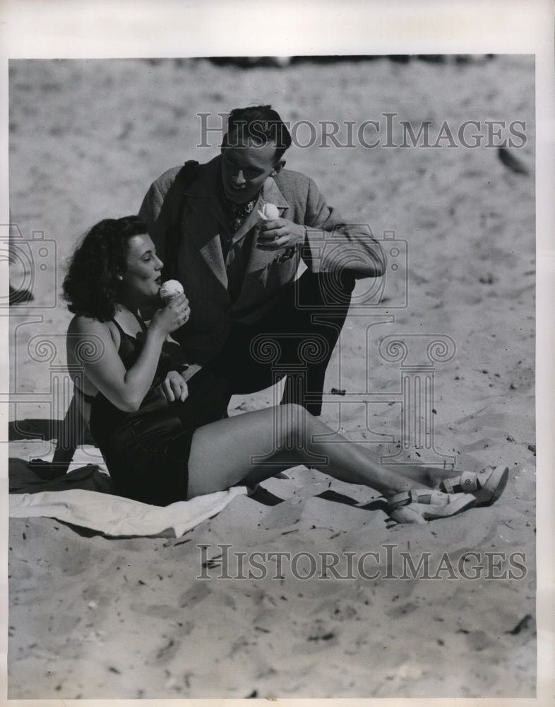 Load image into Gallery viewer, 1947 Press Photo Corliis Colton Eats Ice Cream with a Young Man
