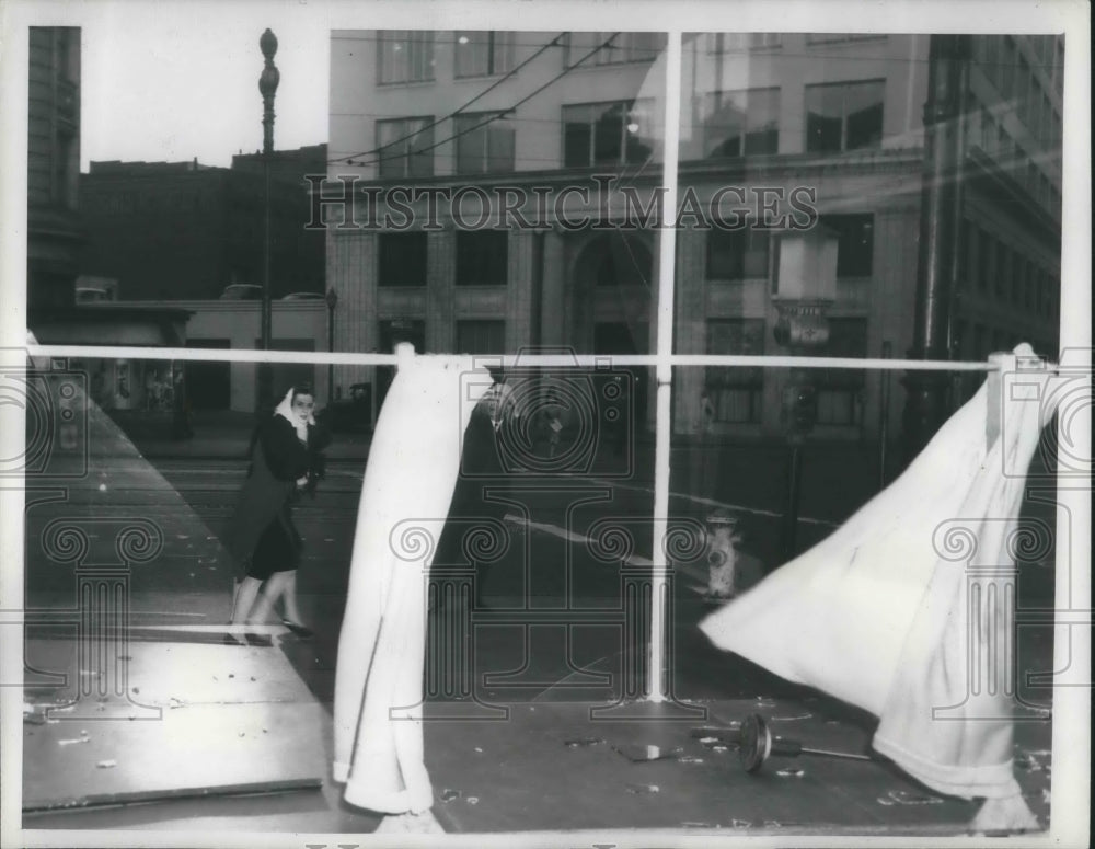 1943 Press PhotoResidents hang onto their hats as winds blow