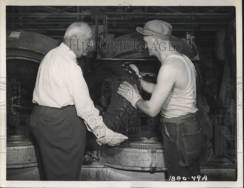 Load image into Gallery viewer, 1949 Press Photo P.W. Litchfield assist in completion of 475 millionth Tire.
