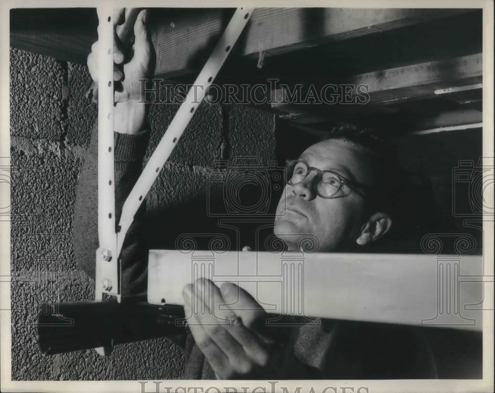 1960 Press Photo An unidentified man using a level to square his work