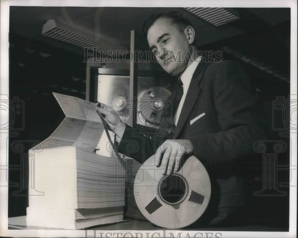1957 Press Photo John L Ogle holding a roll of Social Security tape