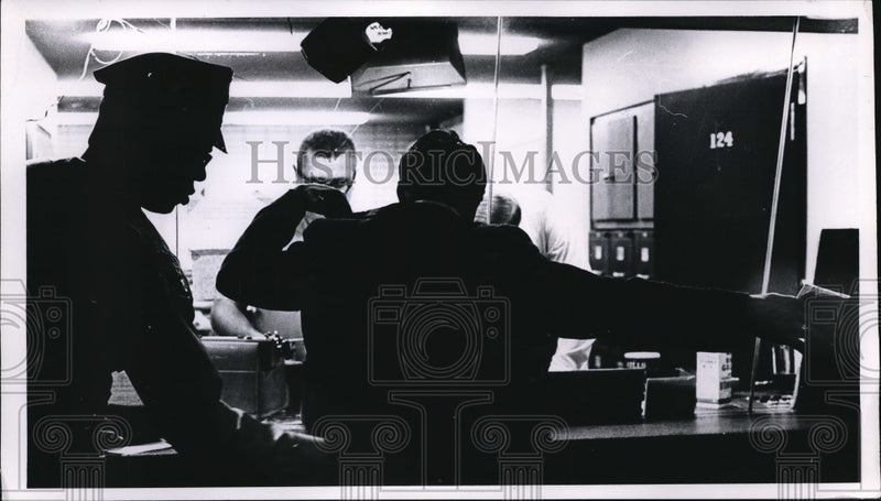 Load image into Gallery viewer, 1968 Press Photo Ptl. Darlice Ogletree checks weapons before booking prisoner
