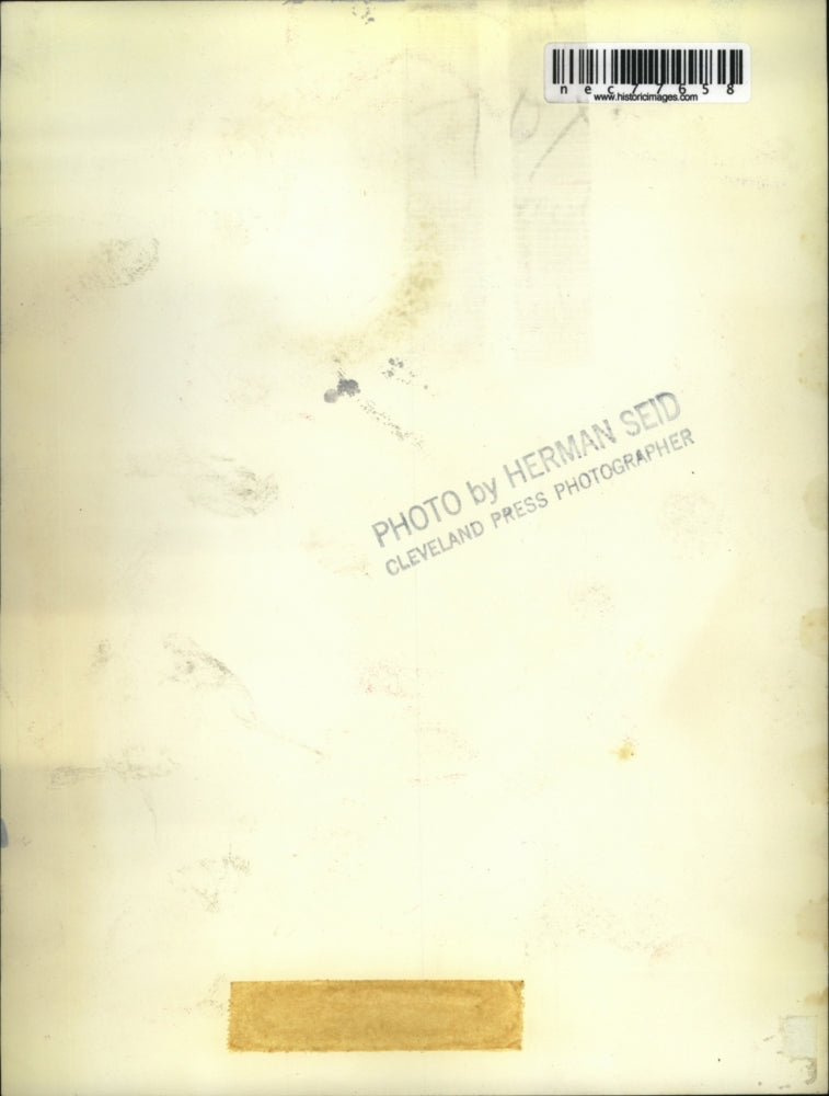 Press Photo Student with "Production" book in hand