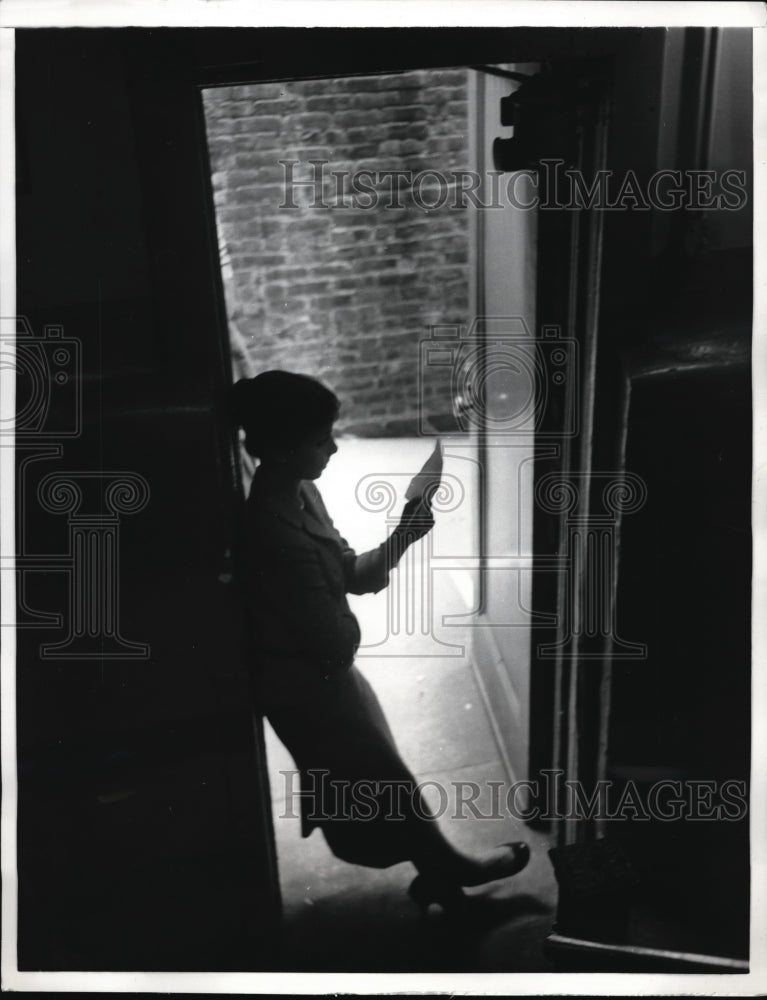 Load image into Gallery viewer, 1957 Press Photo Liza Elliot studies script in the light from the alley.
