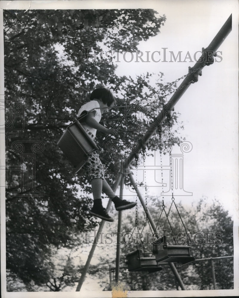 1959 Press Photo Susan O'Brien swings on playground at McKinley Park