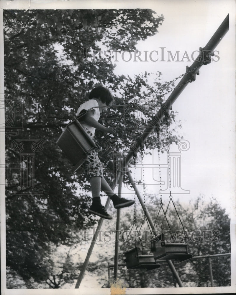Load image into Gallery viewer, 1959 Press Photo Susan O'Brien swings on playground at McKinley Park
