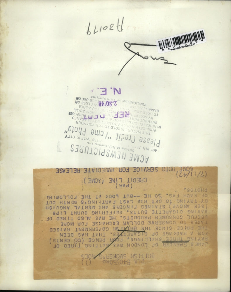 1948 Press Photo James Spencer smokes a cigarette all the way down due to the