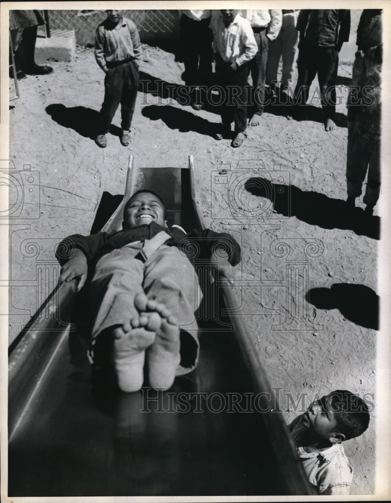 Load image into Gallery viewer, 1971 Press Photo Patzun boy sliding down slide
