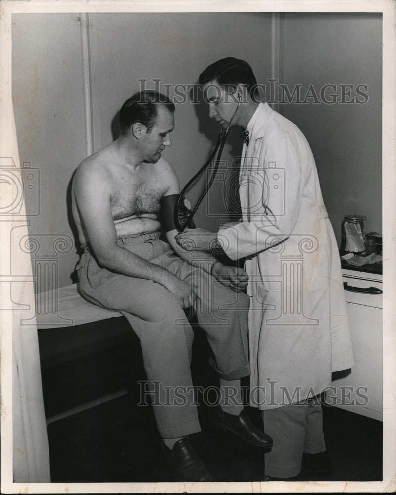 Load image into Gallery viewer, 1954 Press Photo Dr William Moir with patient Peter Boruch for BP test
