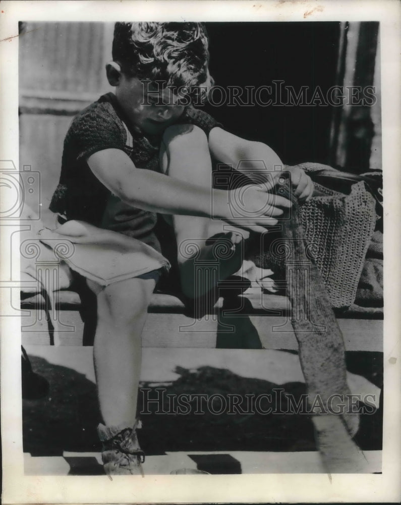Load image into Gallery viewer, 1945 Press Photo Little Daniel Soudey of Rouen France tries pair of woolen socks
