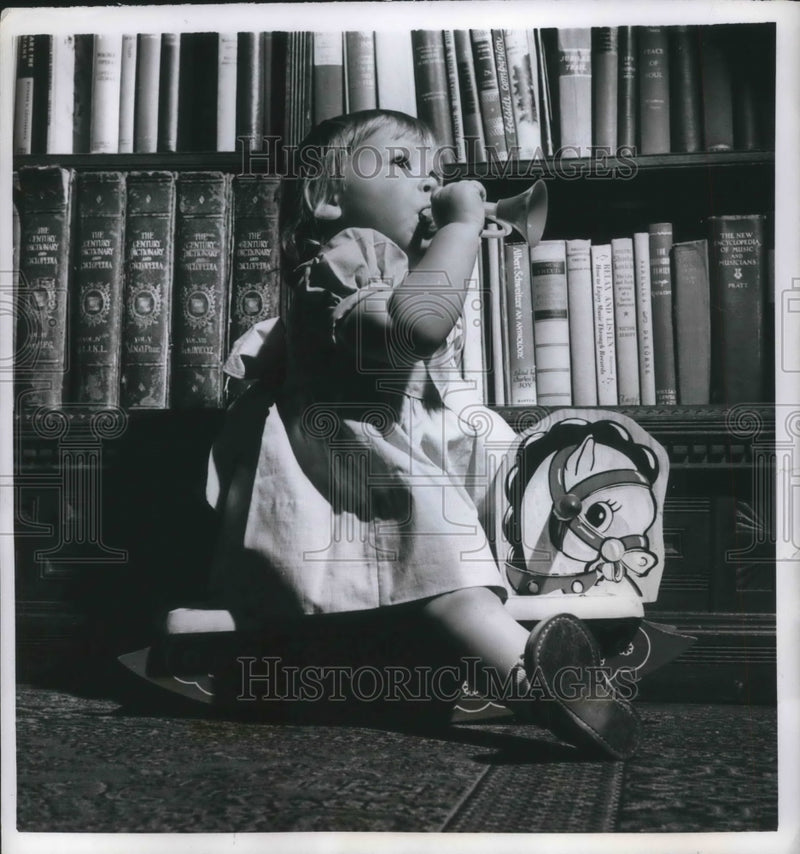 Load image into Gallery viewer, 1952 Press Photo Allison List on a hobby horse with a toy horn
