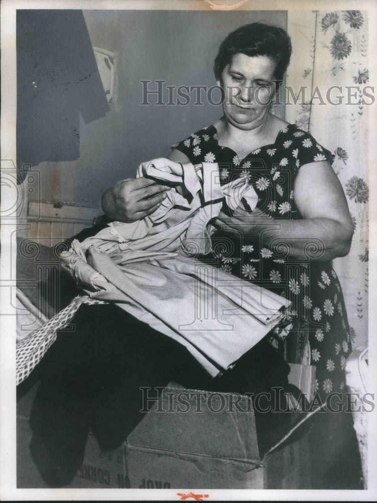Load image into Gallery viewer, 1961 Press Photo Mrs Edward Dapo with gifts after husbands funeral
