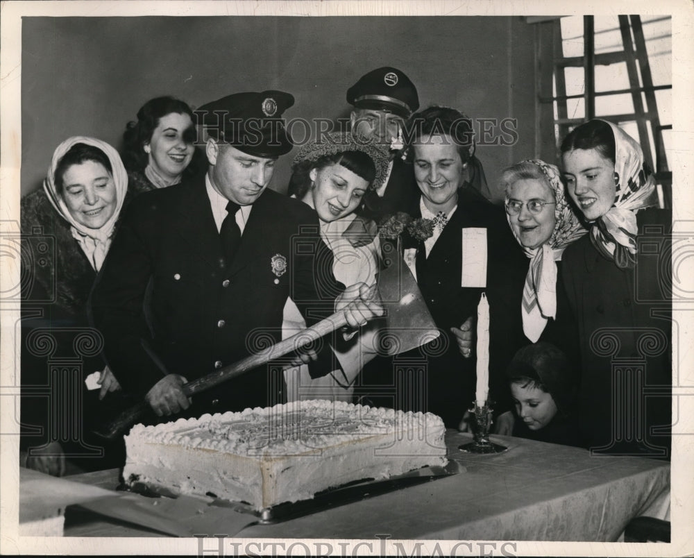 1949 Press Photo Joseph McFarland, Fireman Axing Cake