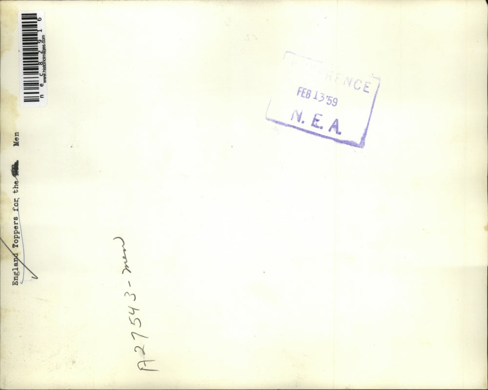 1939 Press Photo A man holding England Toppers for men in a shop