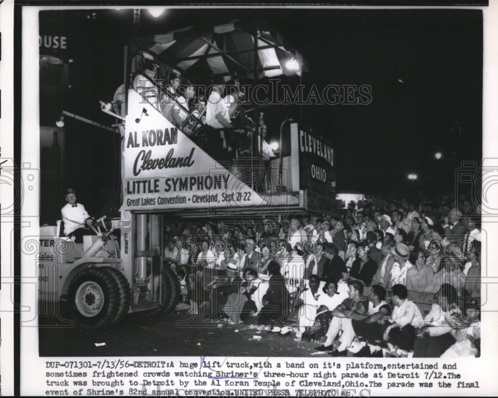 1956 Press Photo A lift truck in Detroit parading down the street with a band