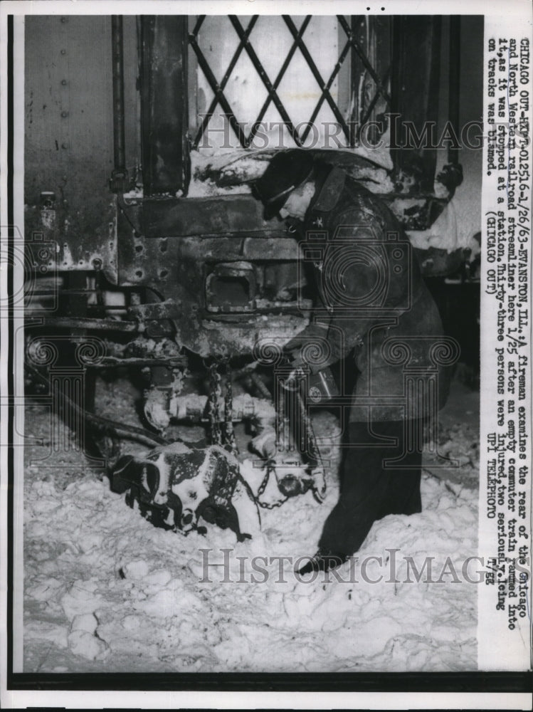 1963 Press Photo Fireman examines Chicago streamliner after accident- Historic Images