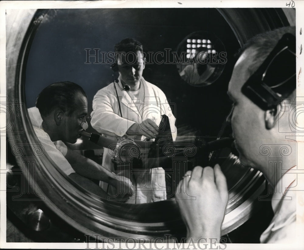 Press Photo Man exercising in space capsule simulator for weightless perils