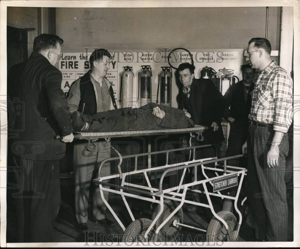 1954 Press Photo Group of men on stretcher carrier