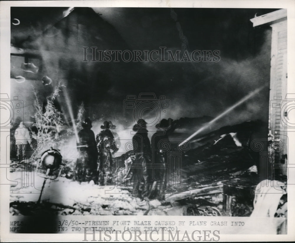 1950 Press Photo Firemen battle blaze at crashed plane in a building