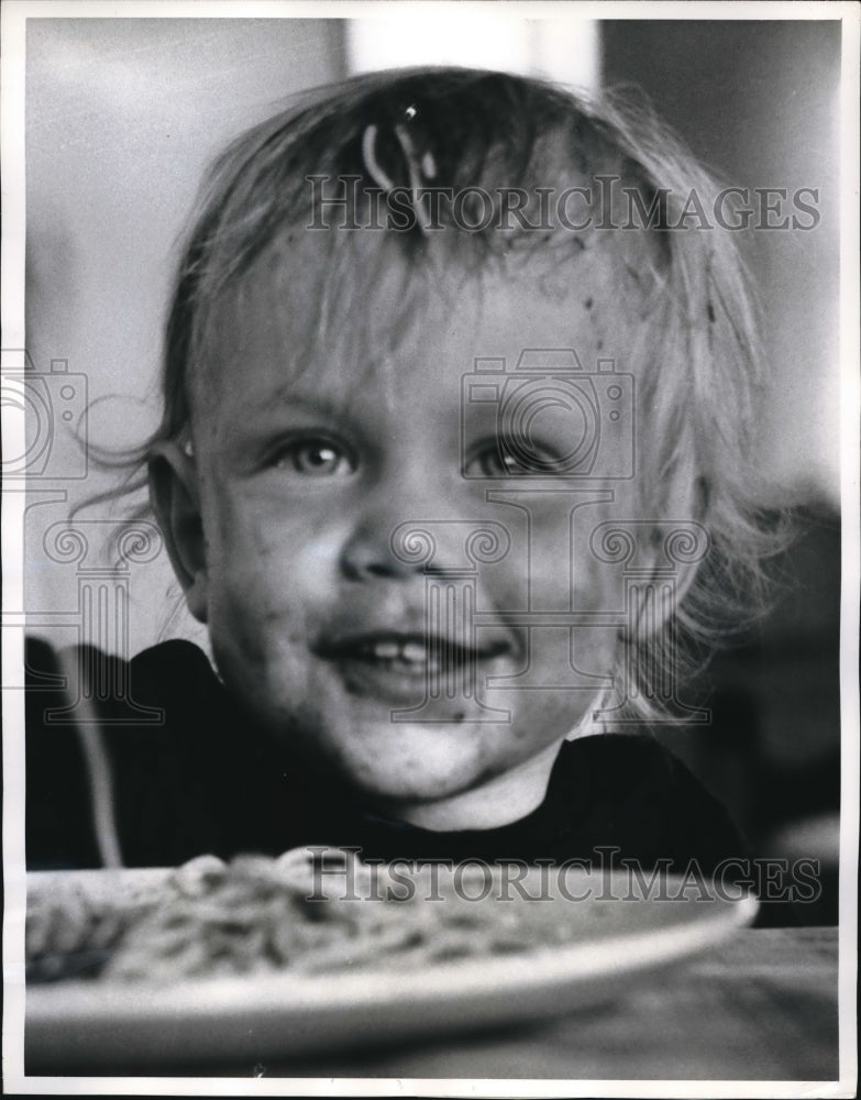 Load image into Gallery viewer, 1961 Press Photo Deirdre with a noodle bow and red smeared grin had her filll
