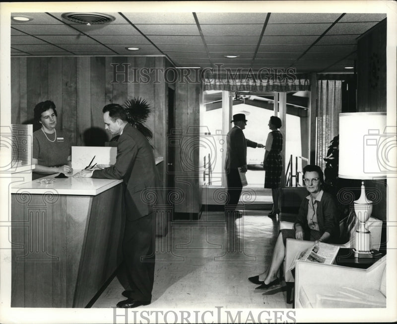 Load image into Gallery viewer, 1964 Press Photo Checking In Motel Lobby
