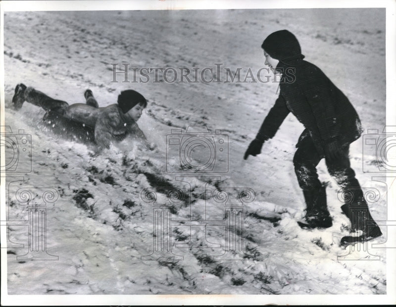 Load image into Gallery viewer, 1962 Press Photo Larry Duffy &amp; Herbert Carrigan sledding in Cleveland
