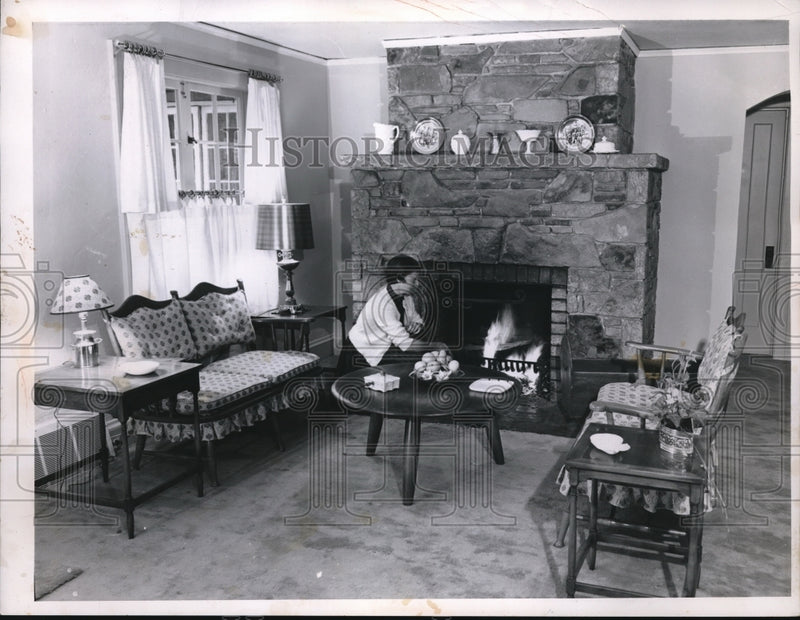 Load image into Gallery viewer, 1955 Press Photo Mrs. Kelly tends a fire in the fireplace in cold days
