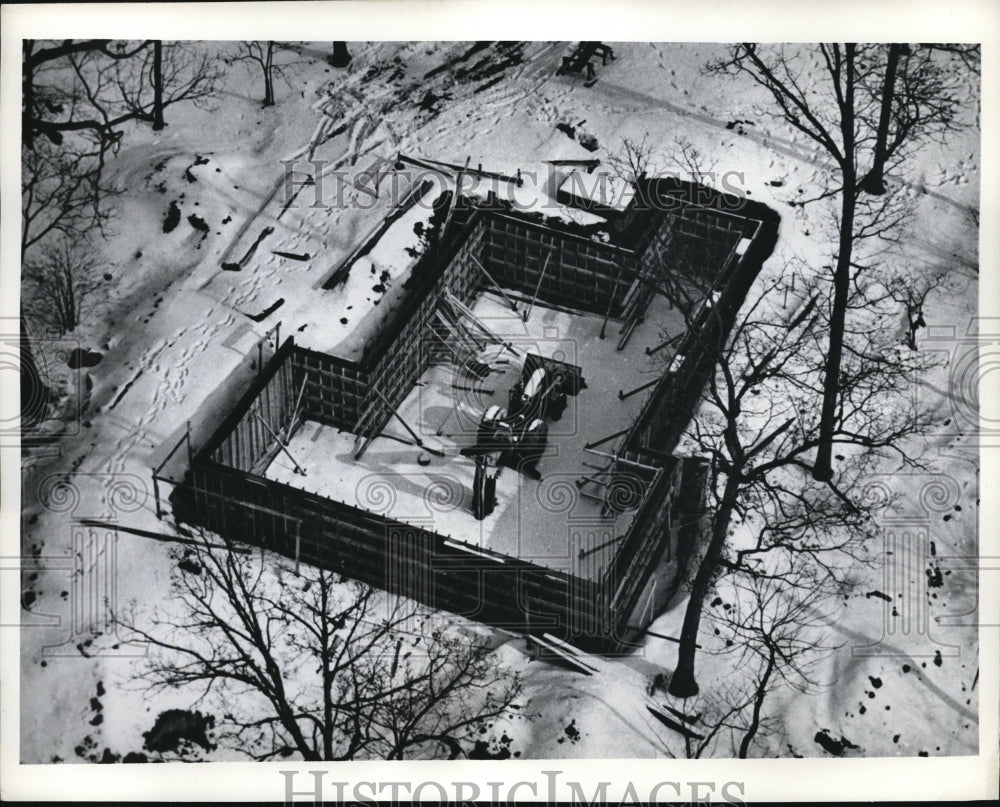 Press Photo Tractor remains inside a homes foundation