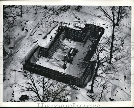 Press Photo Tractor remains inside a homes foundation