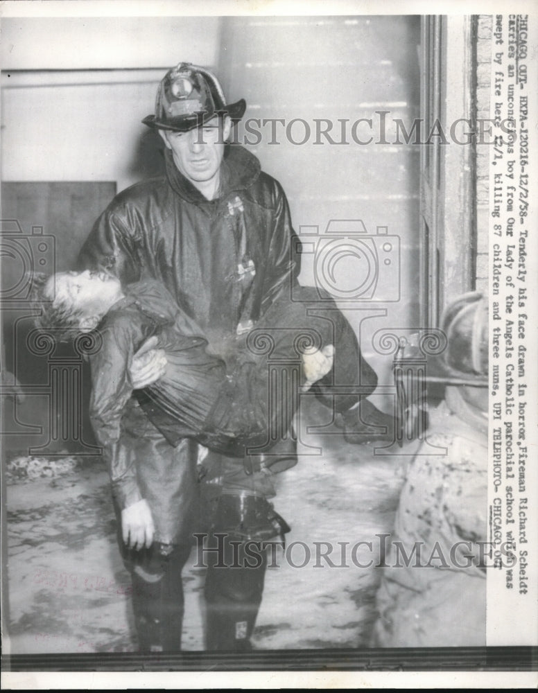 1958 Press Photo Fireman Richard Scheidt with victim at Our Lady of Angel school fire in Chicago