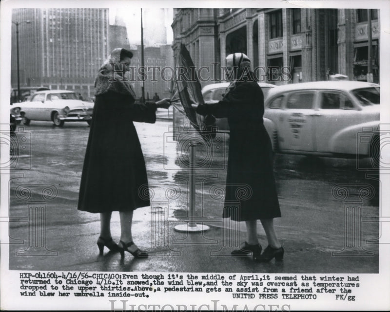 Load image into Gallery viewer, 1956 Press Photo Chicago Illinois Women Struggle With Umbrella In Windy Weather
