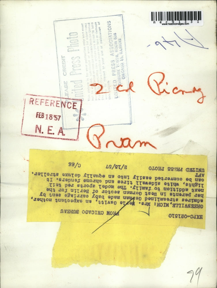 1957 Press Photo Mrs. Merle Gavitt admires streamlined German made baby carriage