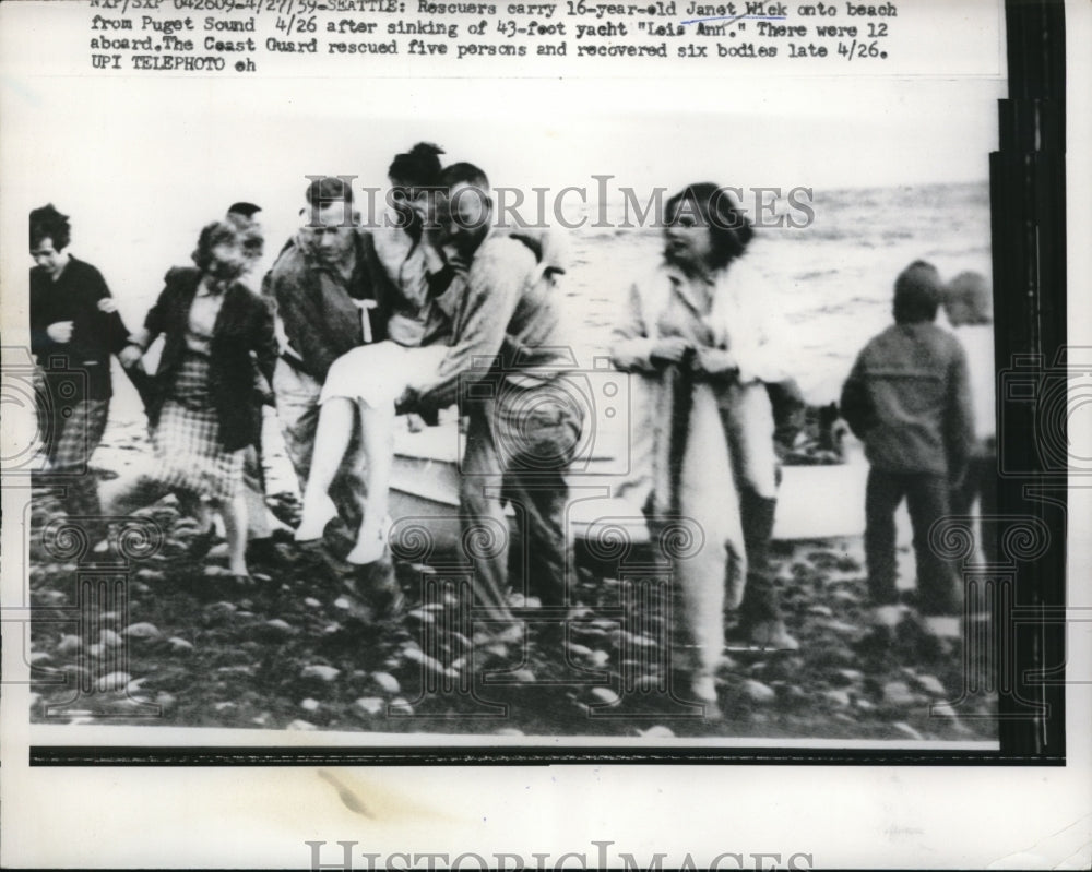 1959 Press Photo Rescuers carry Janet Wick,16 on beach at Puget Sound