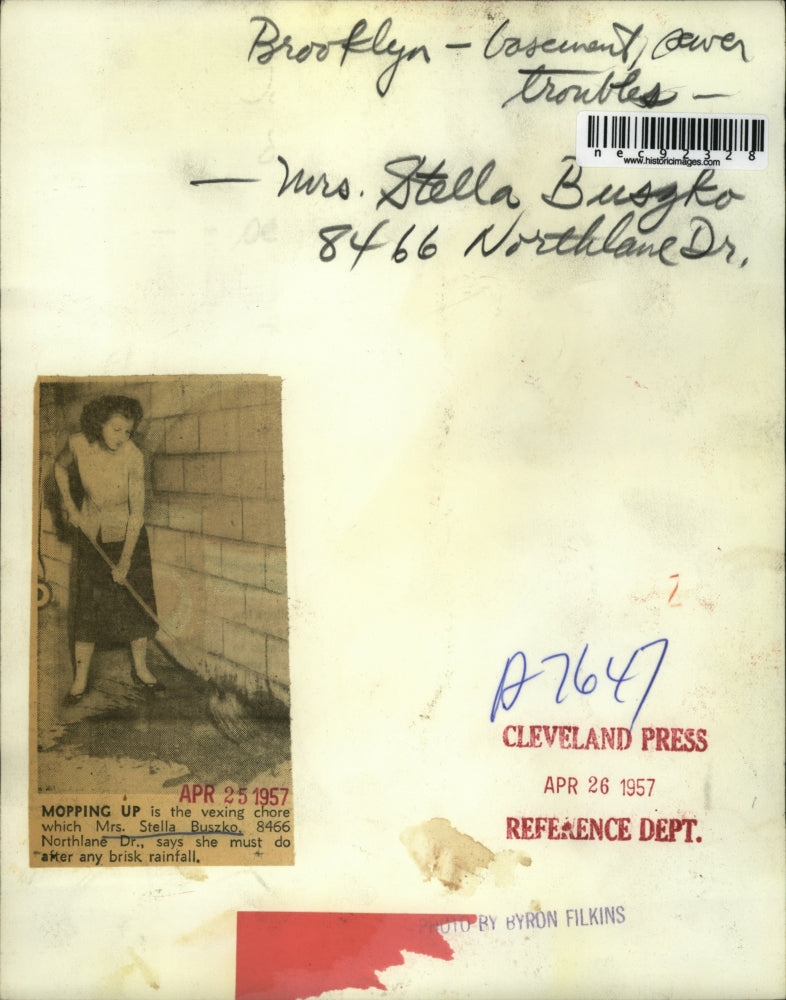 1957 Press Photo Mrs Stella Buszko Mops After Rain Due to Sewer Problem