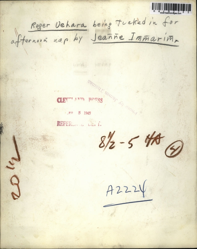 1945 Press Photo Roger Vehara being tucked in for nap by Jeanne Immarim.